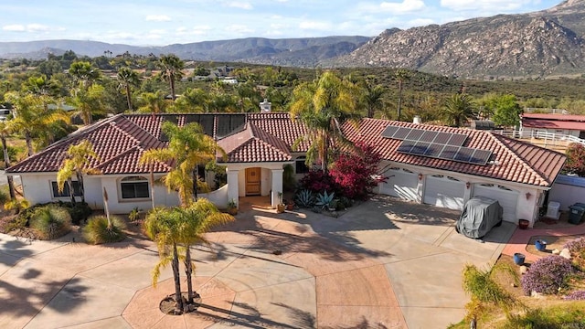 25444 Rancho Barona Rd, Ramona, CA 92065 - mediterranean / spanish-style house featuring a tiled roof, a mountain view, roof mounted solar panels, and stucco siding