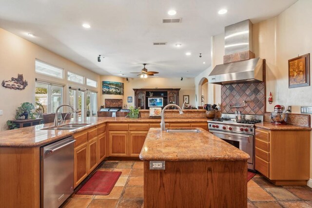 25444 Rancho Barona Rd, Ramona, CA 92065 - kitchen featuring appliances with stainless steel finishes, wall chimney exhaust hood, a center island with sink, a sink, and recessed lighting