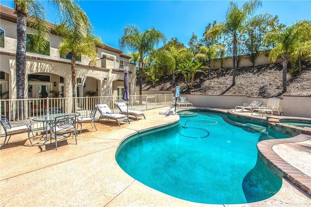 652 Fairway Dr, Redlands, CA 92373 - view of swimming pool featuring a patio, fence, a pool with connected hot tub, and french doors