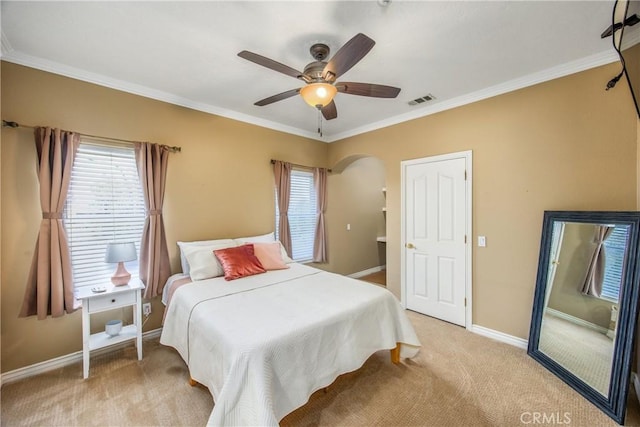 652 Fairway Dr, Redlands, CA 92373 - bedroom featuring multiple windows, crown molding, baseboards, light carpet, and arched walkways