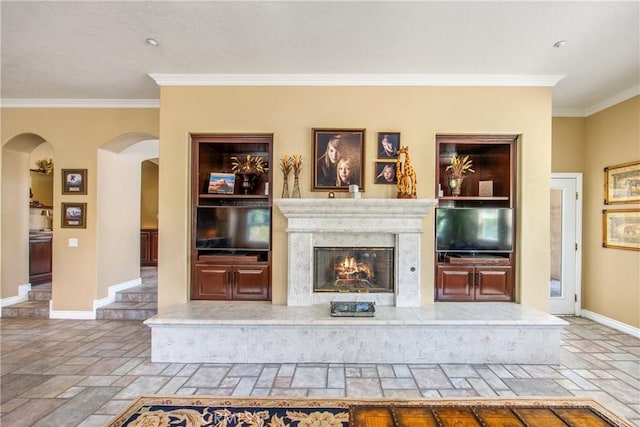 652 Fairway Dr, Redlands, CA 92373 - unfurnished living room with crown molding, arched walkways, baseboards, stone tile floors, and a premium fireplace