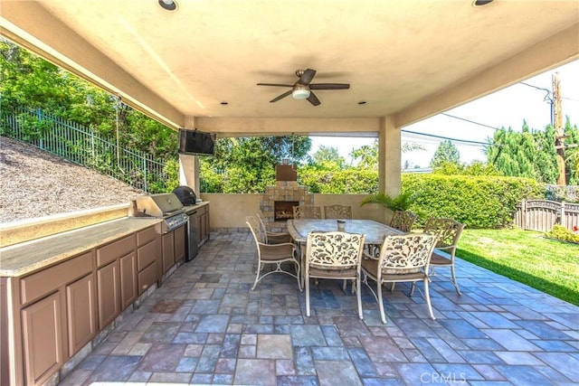 652 Fairway Dr, Redlands, CA 92373 - view of patio featuring fence, area for grilling, an outdoor stone fireplace, and outdoor dining space