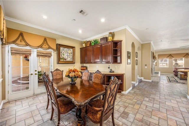 652 Fairway Dr, Redlands, CA 92373 - dining room with arched walkways, baseboards, ornamental molding, recessed lighting, and french doors