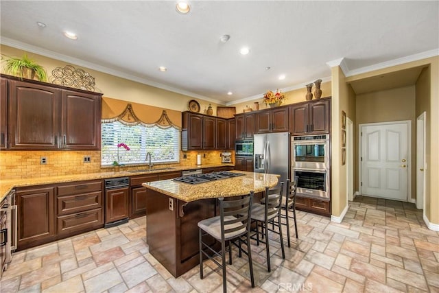 652 Fairway Dr, Redlands, CA 92373 - kitchen featuring a sink, appliances with stainless steel finishes, a breakfast bar, a center island, and light stone counters