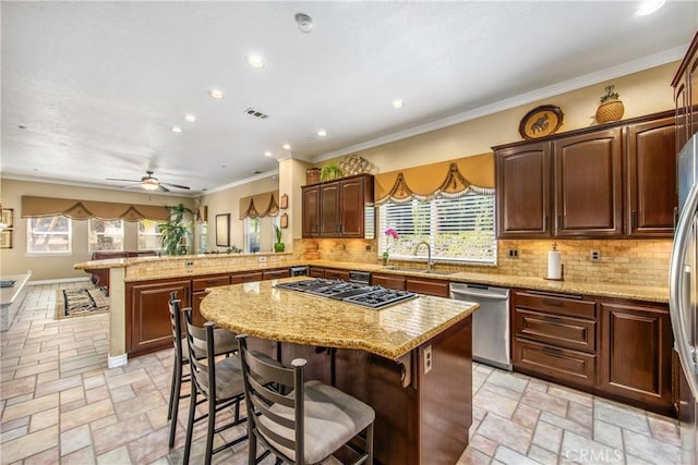 652 Fairway Dr, Redlands, CA 92373 - kitchen with appliances with stainless steel finishes, a sink, a peninsula, stone tile floors, and a kitchen breakfast bar