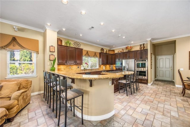 652 Fairway Dr, Redlands, CA 92373 - kitchen featuring a breakfast bar area, ornamental molding, stainless steel appliances, baseboards, and recessed lighting