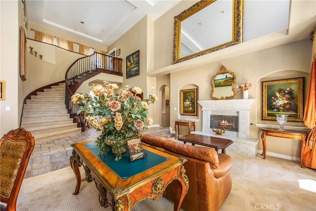 652 Fairway Dr, Redlands, CA 92373 - living area with stairway, a high end fireplace, a high ceiling, and baseboards