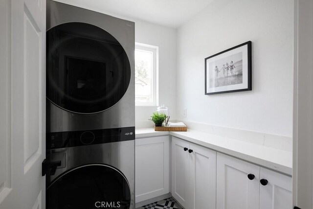 24411 Kings Vw, Laguna Niguel, CA 92677 - laundry area featuring stacked washer / dryer and cabinet space