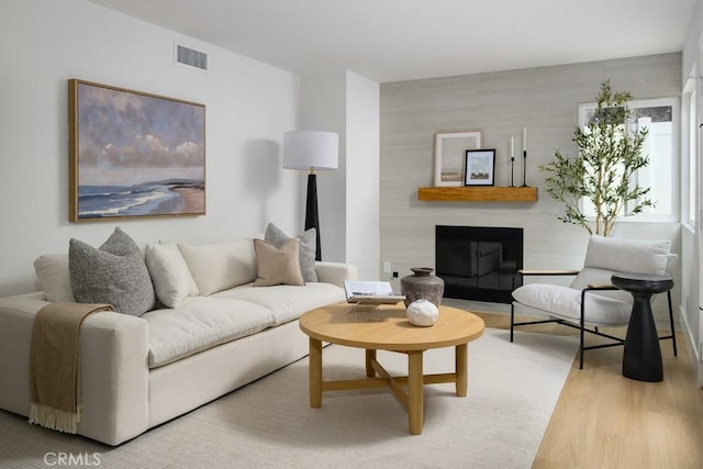 24411 Kings Vw, Laguna Niguel, CA 92677 - living area featuring visible vents, wood finished floors, and a fireplace