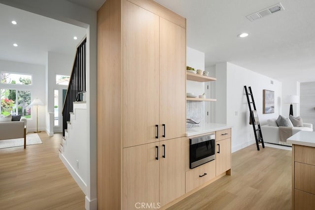 24411 Kings Vw, Laguna Niguel, CA 92677 - kitchen with light brown cabinets, open floor plan, modern cabinets, and recessed lighting