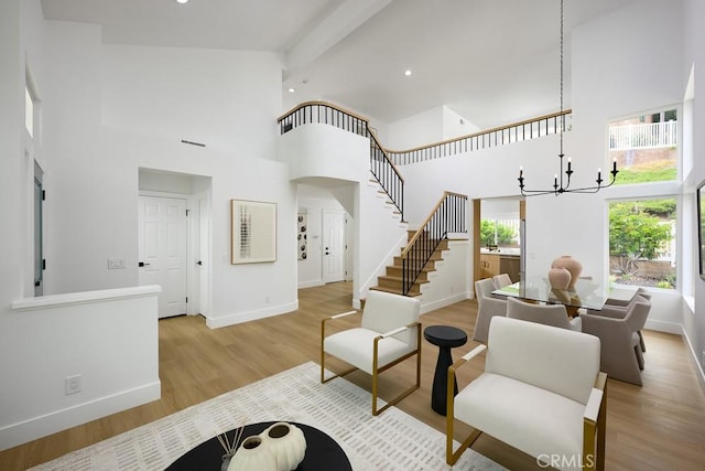 24411 Kings Vw, Laguna Niguel, CA 92677 - living area featuring a towering ceiling, a chandelier, stairs, light wood finished floors, and recessed lighting