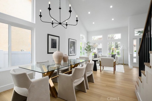 24411 Kings Vw, Laguna Niguel, CA 92677 - dining room featuring high vaulted ceiling, stairs, light wood-style floors, recessed lighting, and a chandelier