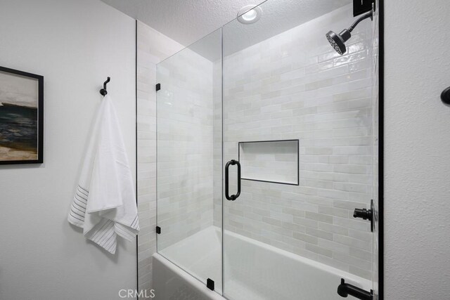 24411 Kings Vw, Laguna Niguel, CA 92677 - bathroom featuring a textured ceiling and combined bath / shower with glass door
