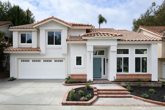 24411 Kings Vw, Laguna Niguel, CA 92677 - mediterranean / spanish-style home featuring concrete driveway, an attached garage, stucco siding, and a tile roof