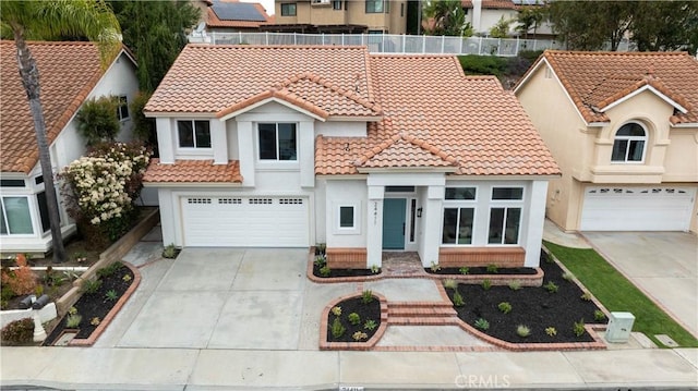24411 Kings Vw, Laguna Niguel, CA 92677 - mediterranean / spanish house featuring a tiled roof, concrete driveway, an attached garage, and stucco siding