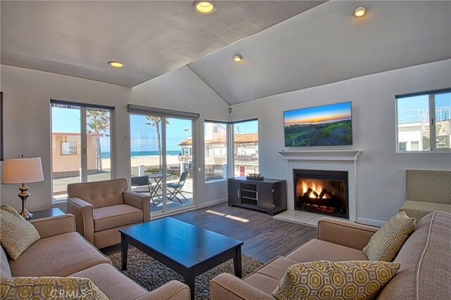 6711 Seashore Dr, Newport Beach, CA 92663 - living room featuring recessed lighting, a tile fireplace, vaulted ceiling, baseboards, and wood finished floors