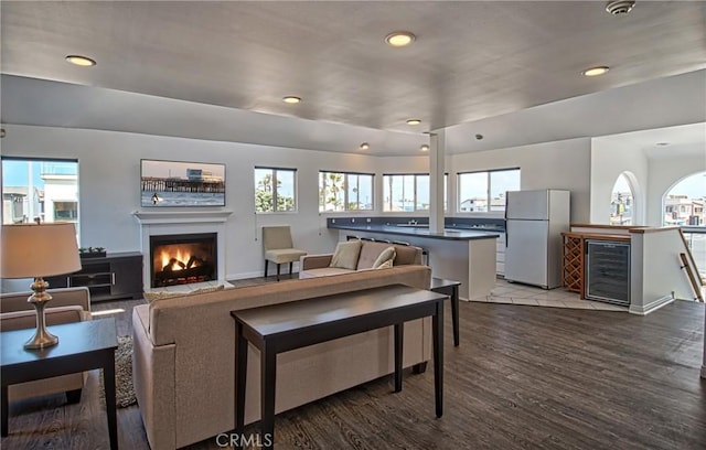 6711 Seashore Dr, Newport Beach, CA 92663 - living area with a warm lit fireplace, wine cooler, recessed lighting, and plenty of natural light