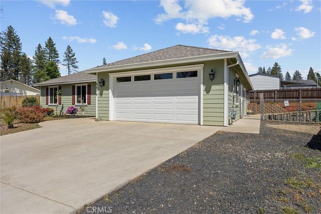 ranch-style house with a garage, fence, a shingled roof, and driveway