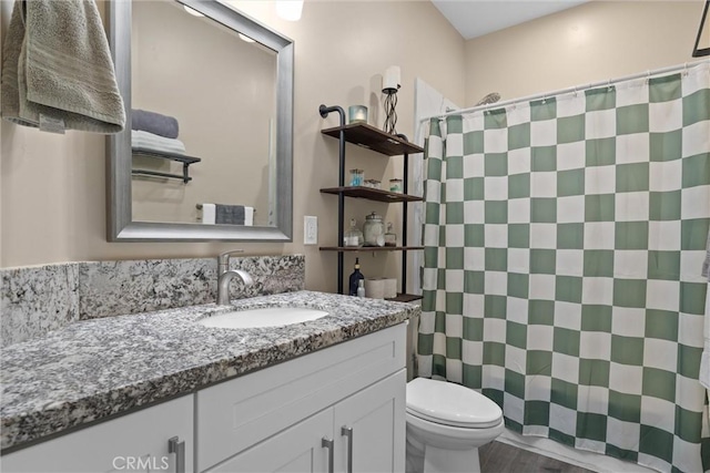 full bathroom with wood finished floors, toilet, a shower with curtain, and vanity