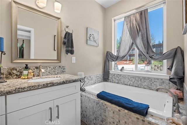full bathroom featuring a bath and vanity