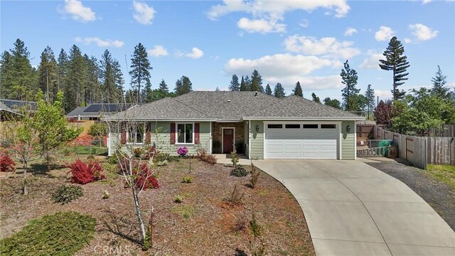 single story home featuring fence, driveway, and an attached garage