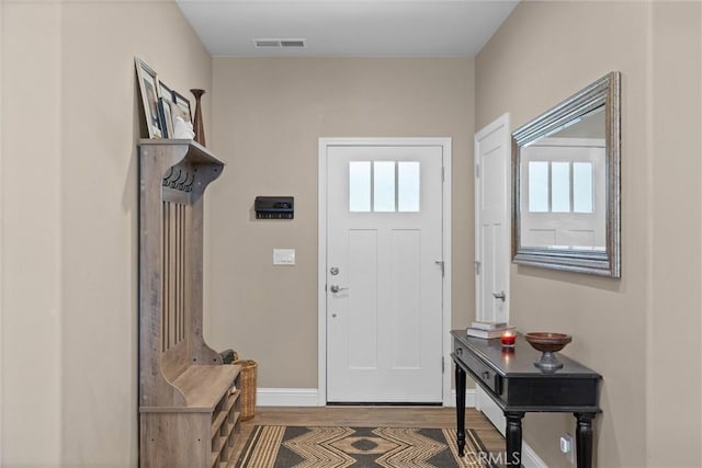 interior space featuring wood finished floors, visible vents, and baseboards