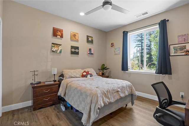 bedroom with recessed lighting, wood finished floors, ceiling fan, baseboards, and visible vents