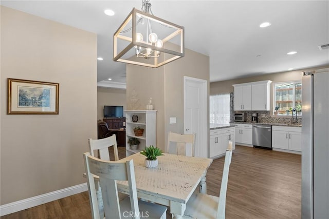 dining area with recessed lighting, a chandelier, visible vents, baseboards, and wood finished floors