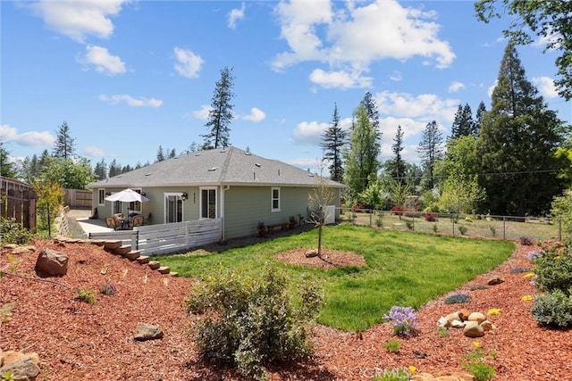 back of house featuring a lawn, a patio area, and a fenced backyard