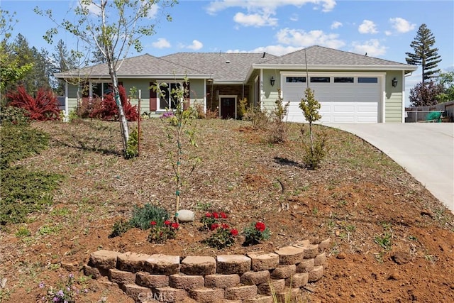 ranch-style house featuring concrete driveway, a shingled roof, and an attached garage