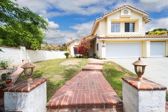 view of yard featuring a garage, fence, and driveway