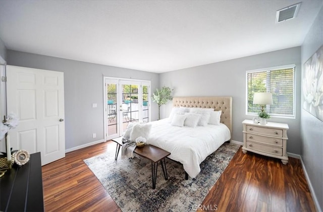 bedroom with dark wood finished floors, visible vents, access to outside, and baseboards