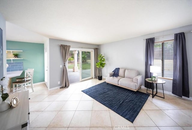 living room featuring light tile patterned floors and baseboards