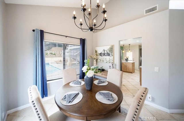 dining area with an inviting chandelier, light tile patterned floors, visible vents, and baseboards