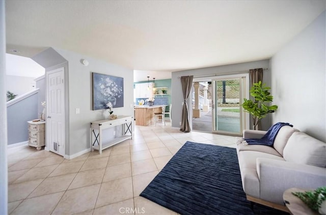 living room featuring light tile patterned flooring and baseboards