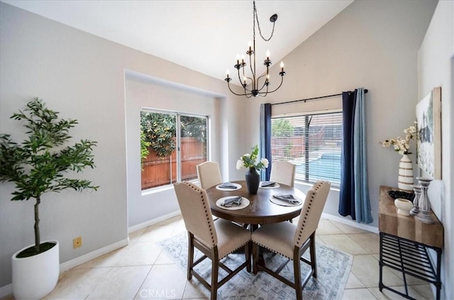 dining space with a chandelier, baseboards, light tile patterned floors, and a wealth of natural light