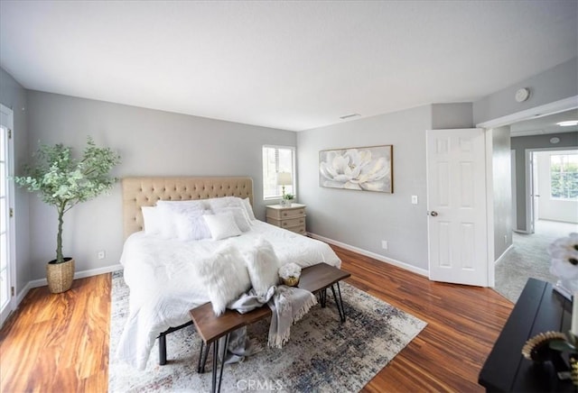 bedroom featuring wood finished floors and baseboards