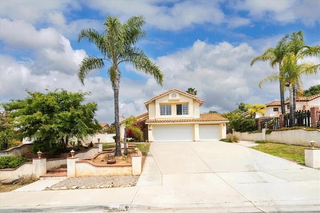 view of front of house featuring a tile roof, an attached garage, driveway, stucco siding, and fence