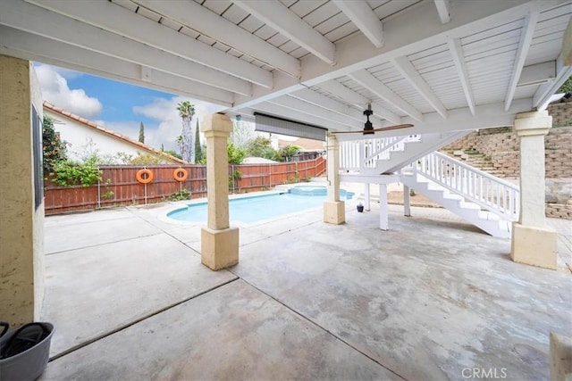 view of swimming pool with a patio area, a fenced in pool, a fenced backyard, stairs, and a ceiling fan
