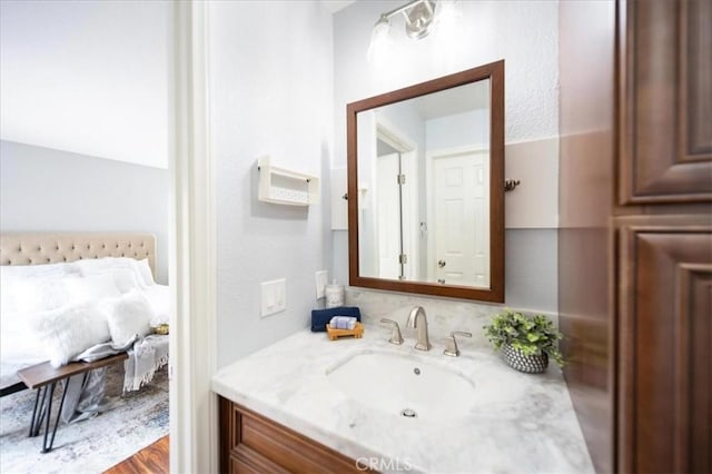 ensuite bathroom featuring ensuite bath and vanity