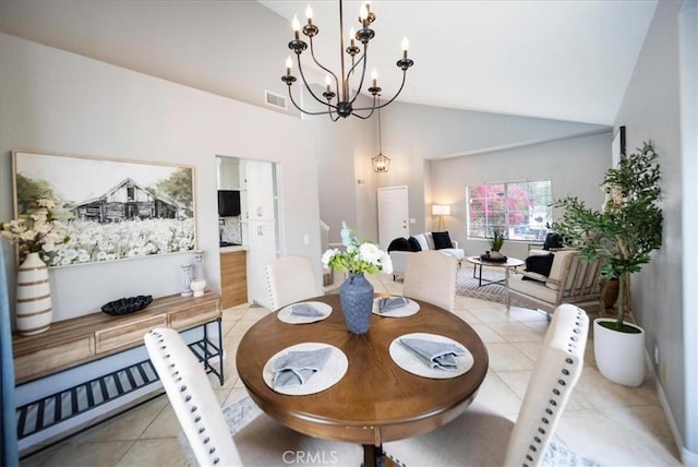 dining area featuring an inviting chandelier, light tile patterned flooring, visible vents, and high vaulted ceiling