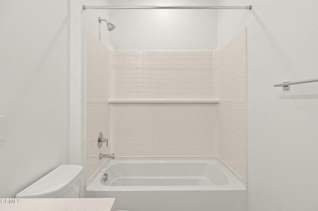 bathroom featuring bathing tub / shower combination and toilet