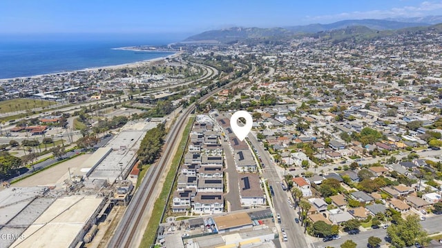 birds eye view of property with a water and mountain view