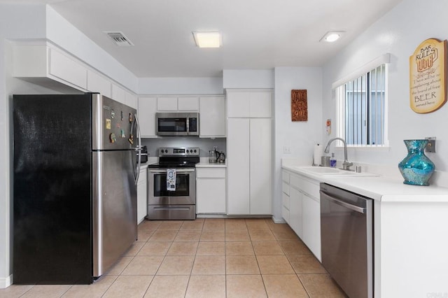 3555 Boussock Ln, Oceanside, CA 92057 - kitchen with appliances with stainless steel finishes, white cabinetry, light countertops, and light tile patterned floors