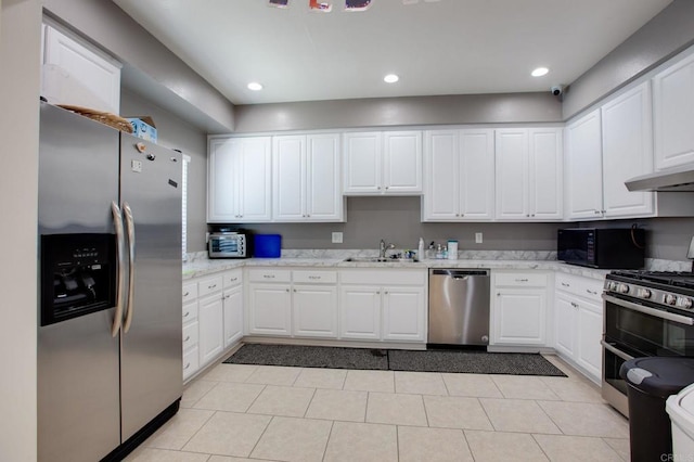 3555 Boussock Ln, Oceanside, CA 92057 - kitchen with appliances with stainless steel finishes, white cabinetry, light tile patterned flooring, and recessed lighting