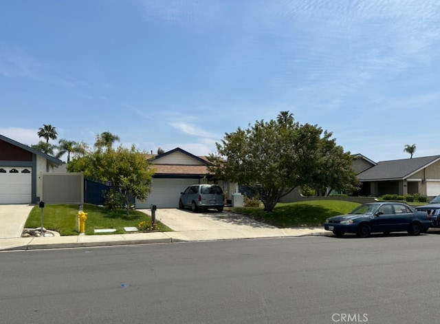 obstructed view of property with driveway and an attached garage