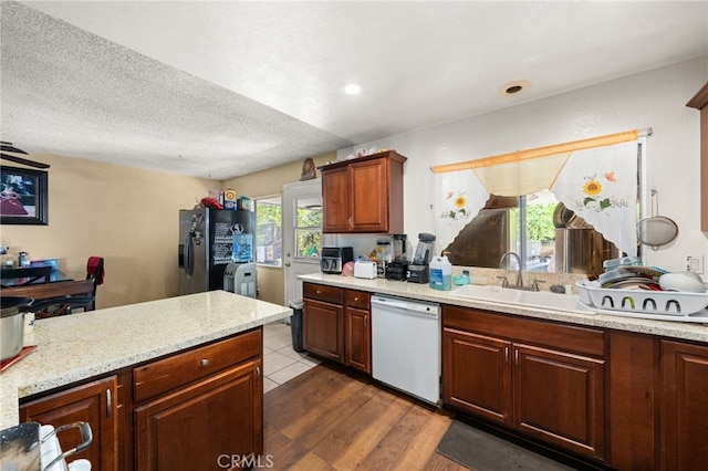 12597 Jalepeno Ave, Chino, CA 91710 - kitchen with dishwasher, a sink, stainless steel fridge, dark wood-style flooring, and a textured ceiling