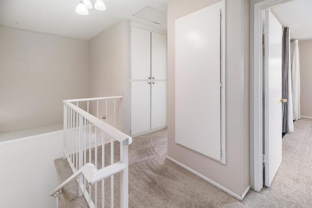 corridor with carpet flooring and baseboards