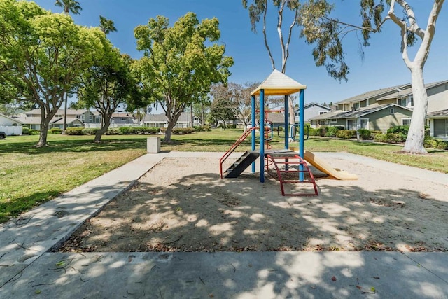 community jungle gym with a yard and a residential view