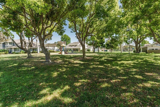 view of yard with playground community and a residential view